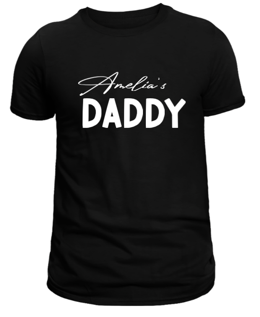 A black T-shirt with the text 'Amelia's DADDY' in white script.