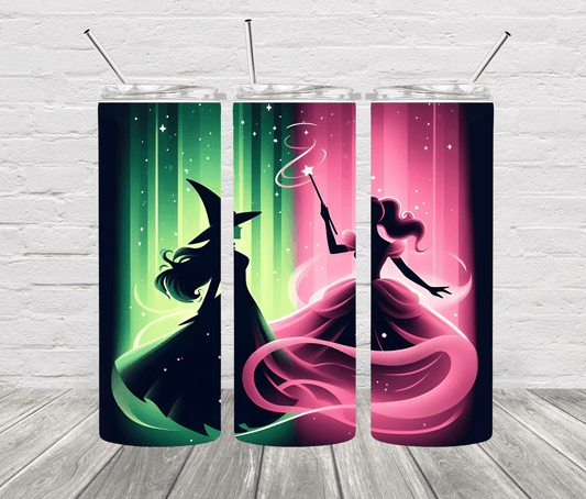 A set of two stainless steel tumblers with one featuring a green witch design and the other a pink princess design, both with black backgrounds and colorful accents, displayed against a white brick wall.