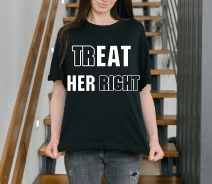 A woman wearing a black T-shirt with the text 'TREAT HER RIGHT' on it, standing in a home setting.